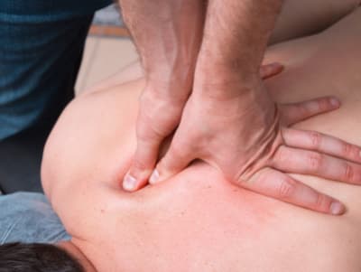 Trigger Point Therapy on a client prone