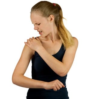 Woman is looking at her shoulder trigger points and touches them